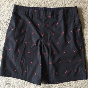Navy blue golf shorts with red pepper pattern
